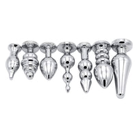 An image showcases a solid, stainless steel vibrating plug, designed for anus play. The metal plug offers a powerful silver e-stim set experience.