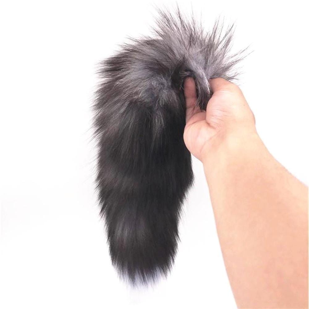 Enhance your experience with this black, white, gray fox tail. sex toys fox fit well, and the light fur makes it even more irresistible.
