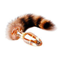 A sleek, durable glass plug with a black clear, and green finish, featuring sex toys raccoon, paired with a brown tail for extra fun.