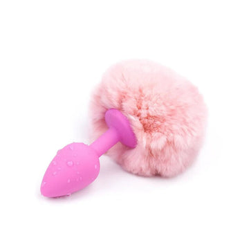A pink, tapered, silicone, bunny plug with plush, synthetic fur rabbit tail butt toys adds a seductive twist to adult play. The white, tail is soft and lush.