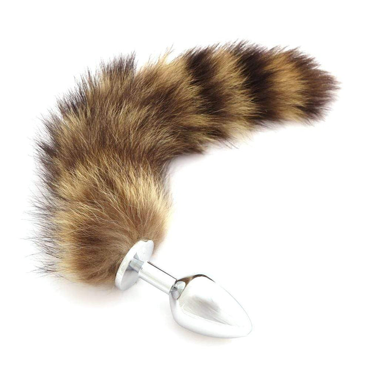 Enhance intimacy with a raccoon tail toy that features soft fur, sleek metal, and a tantalizing black, brown, and silver finish.