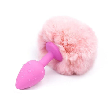A pink, tapered, silicone, bunny plug with plush, synthetic fur rabbit tail butt toys adds a seductive twist to adult play. The white, tail is soft and lush, 